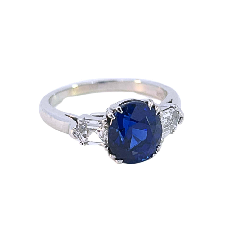 Platinum three stone ring with oval blue sapphire and bullet cut diamonds