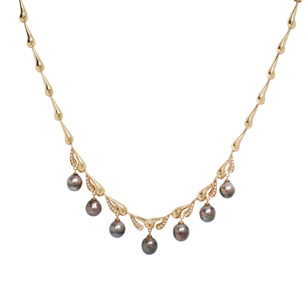 Repetitive teardrop shaped gold necklace with diamonds set on the bottom swirl of eight of the teardrops. Seven gray round Tahitian pearl drops hang from the bottom part of the necklace. 