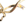 Close-up of the reverse of a Tiffany & Co. gold bow earring, showing the signature area and curved ribbon detail.
