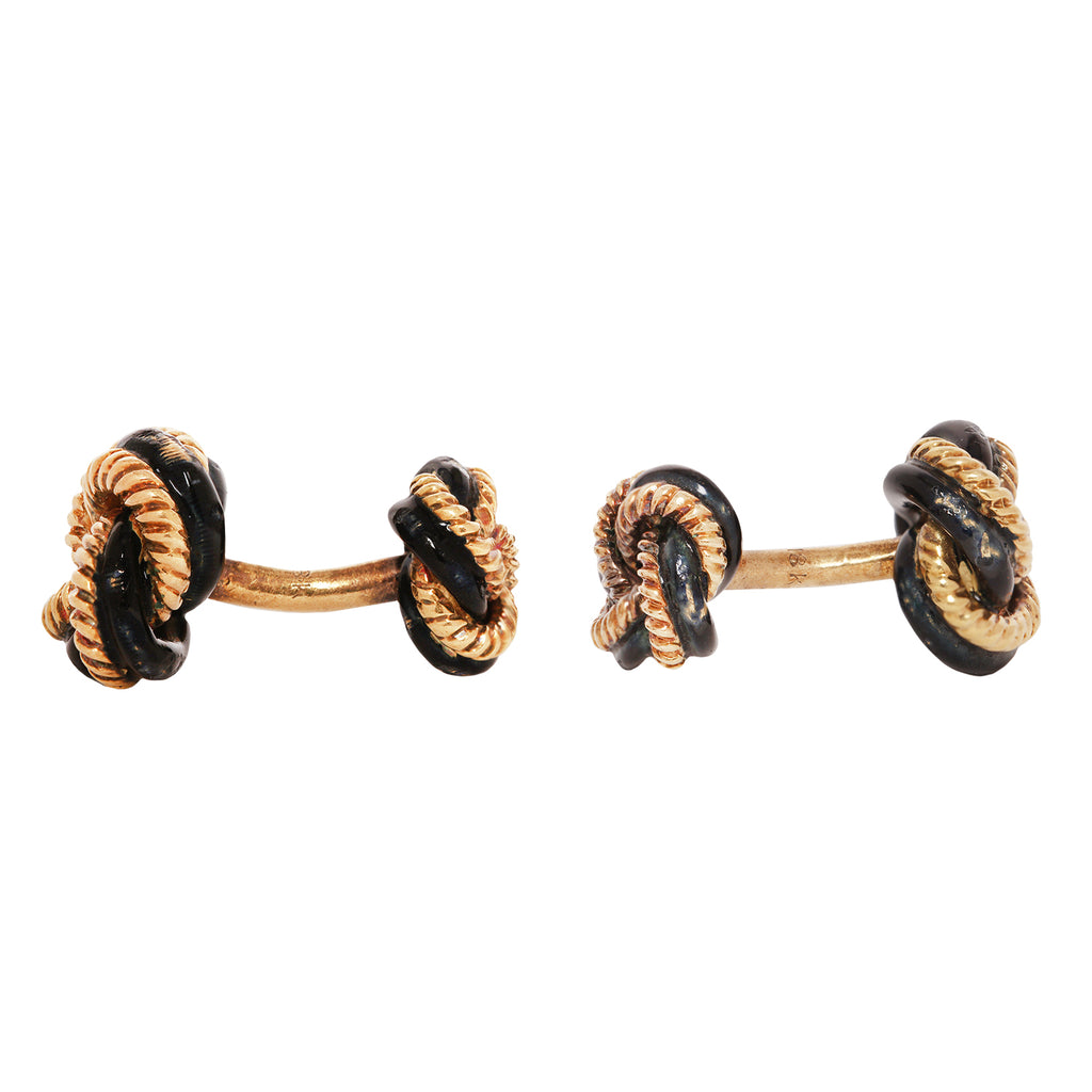 Tiffany & Co. 18K gold dumbbell cufflinks with black enamel knot motif. Estate piece with some enamel damage.