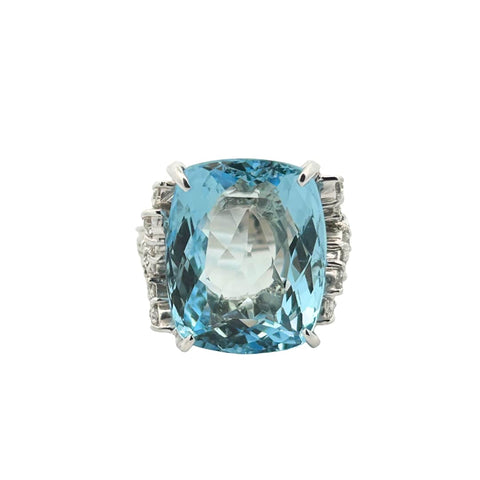 Vintage platinum aquamarine ring featuring a 15.93 carat cushion cut aquamarine with diamond leaf accents