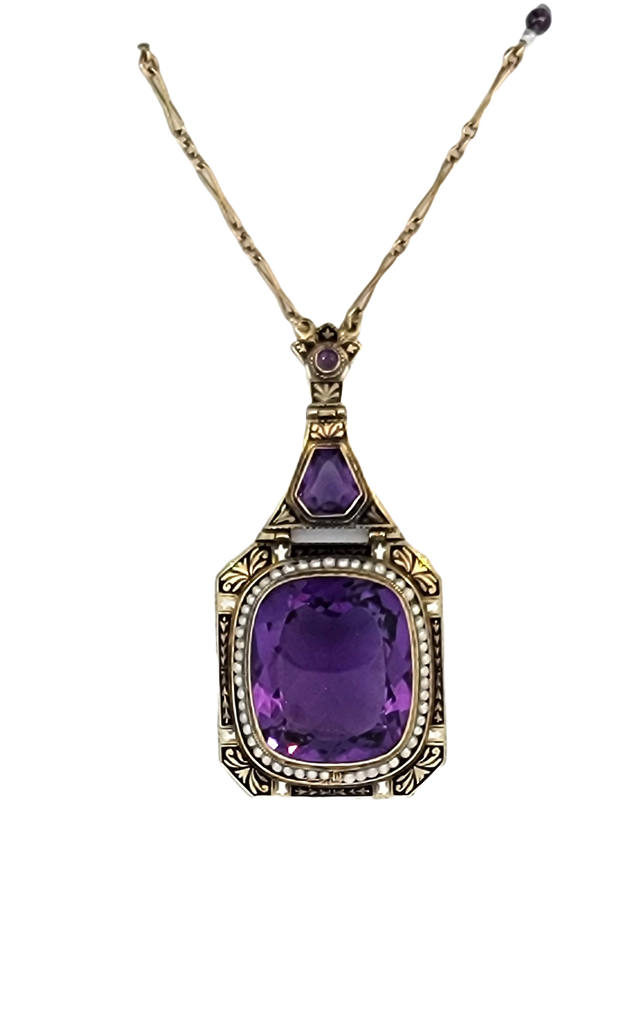 Vintage drop large cushion amethyst in 10k yellow gold and framed with seed pearls and black enamel details necklace.
