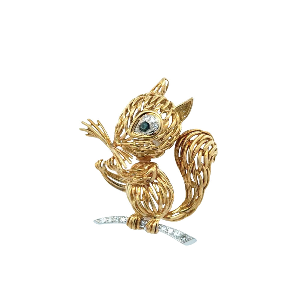 Front view of vintage yellow gold squirrel brooch with sapphire and diamond eye and diamond-set branch