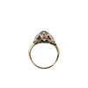 Angled view of an oval aquamarine ring highlighting a white gold butterfly appliqué beside the light blue gemstone.