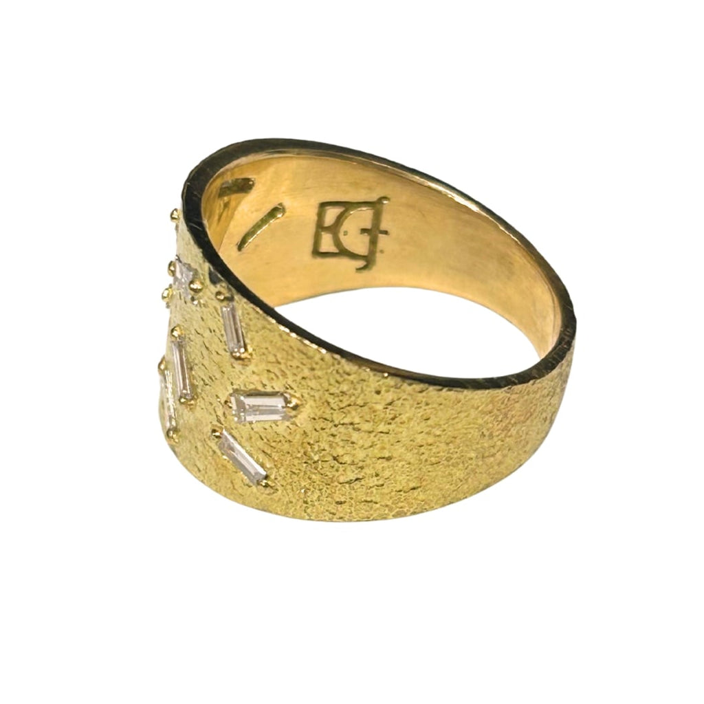 Side view of 18K gold diamond band showing tapered profile