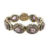 14k yellow gold bracelet featuring nine oval-cut amethysts surrounded by halos of seed pearls.