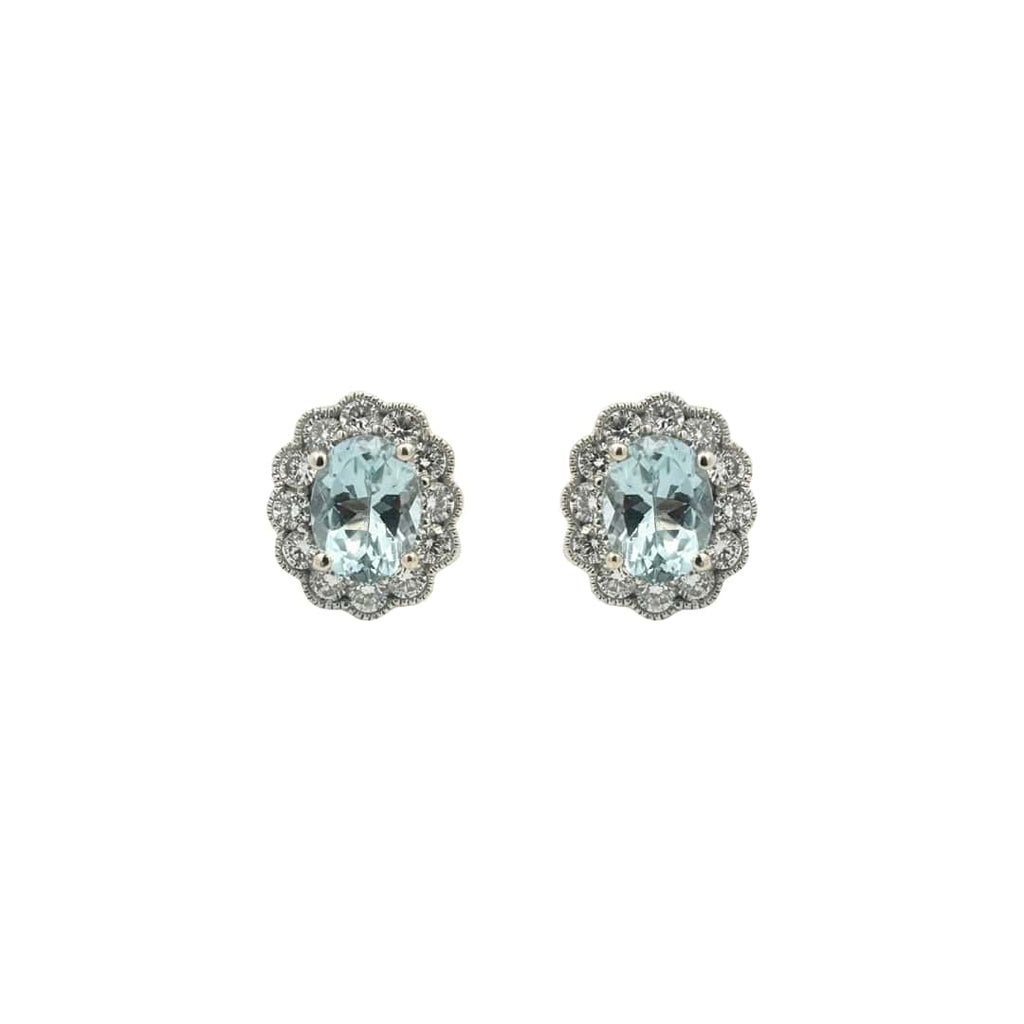 14k white gold earrings with oval aquamarines surrounded by diamond halos and milgrain detail