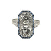 Front view: Art Deco platinum dinner ring with two old European–cut diamonds set north–south and framed by calibre-cut sapphires.