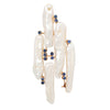 Front view of an abstract brooch featuring long baroque freshwater pearls and blue sapphires set in 18k yellow gold.
