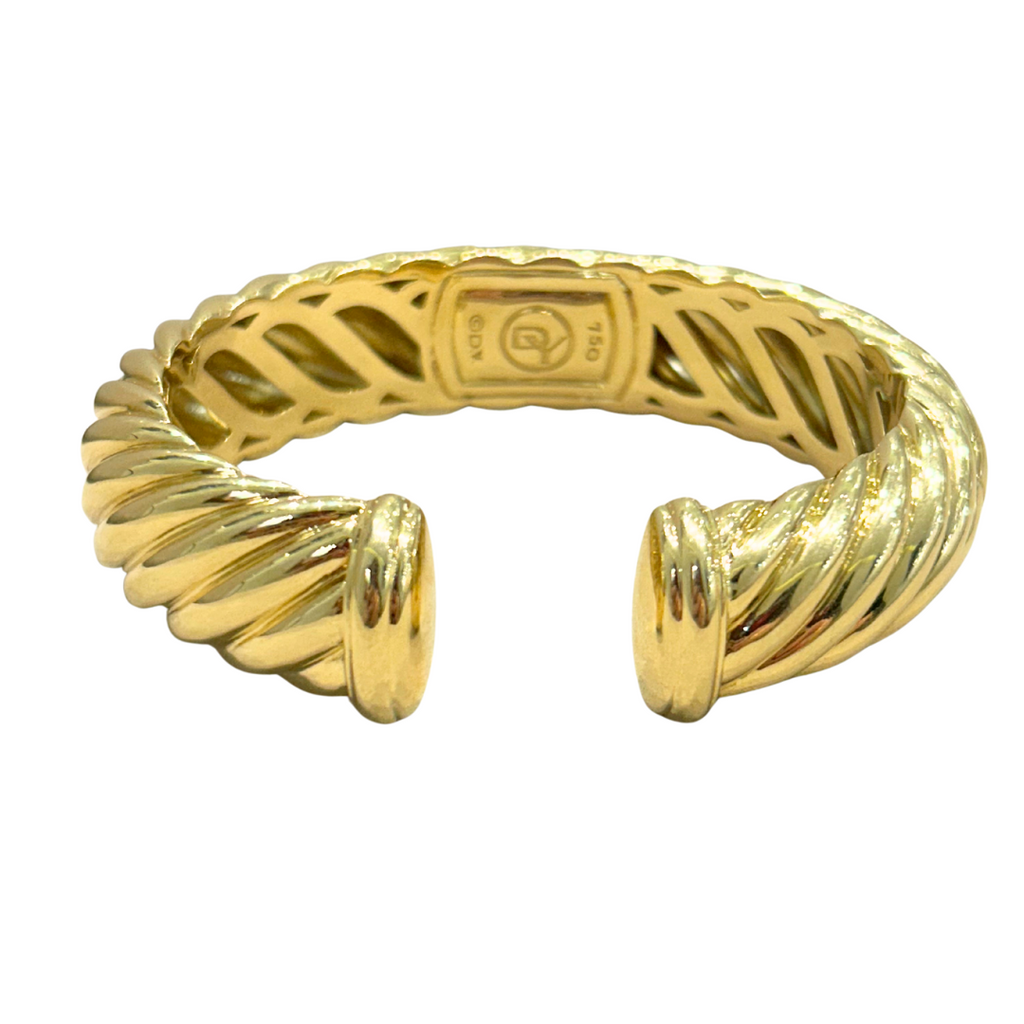 Front view of David Yurman sculpted cable cuff bracelet in 18k yellow gold, showing twisted cable design and open ends.