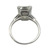 Platinum vintage emerald cut diamond engagement ring featuring a 6.02ct M/VS1 GIA-certified center stone with tapered baguette side diamonds.