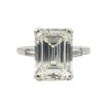 Platinum emerald cut diamond engagement ring featuring a 6.02ct M/VS1 GIA-certified center stone with tapered baguette side diamonds.