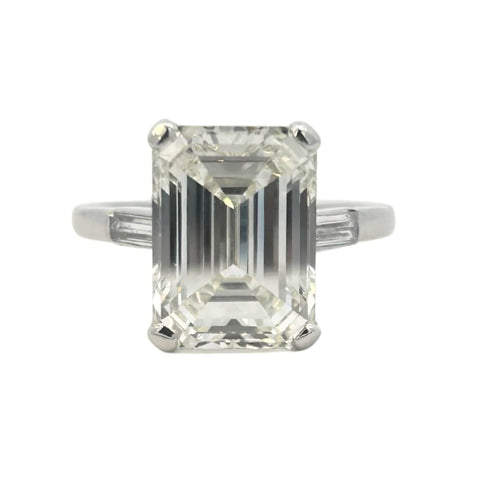 Platinum emerald cut diamond engagement ring featuring a 6.02ct M/VS1 GIA-certified center stone with tapered baguette side diamonds.