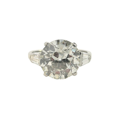 Platinum ring with a 4.95ct European–cut diamond flanked by bullet-shaped side diamonds