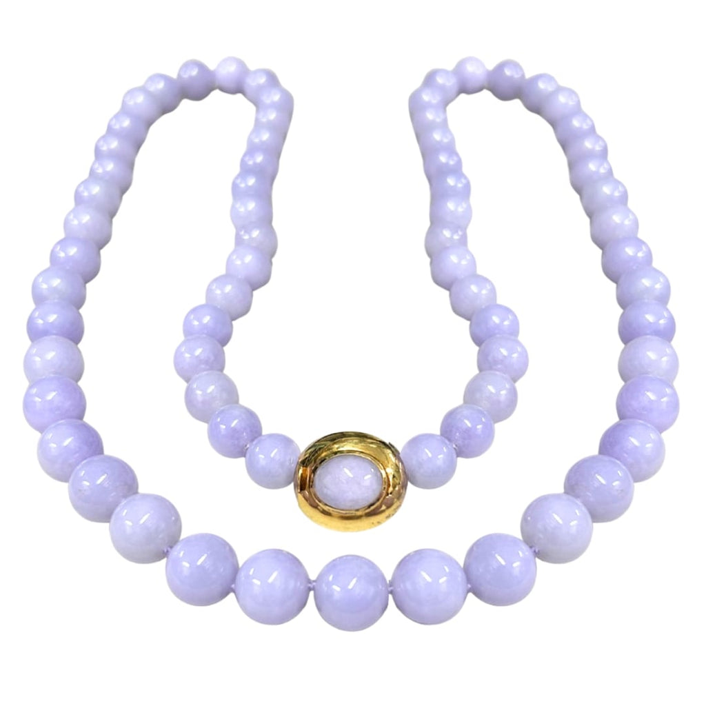 Gump’s 32-inch graduated Type A lavender jade bead necklace with 18k yellow gold clasp set with cabochon jade.