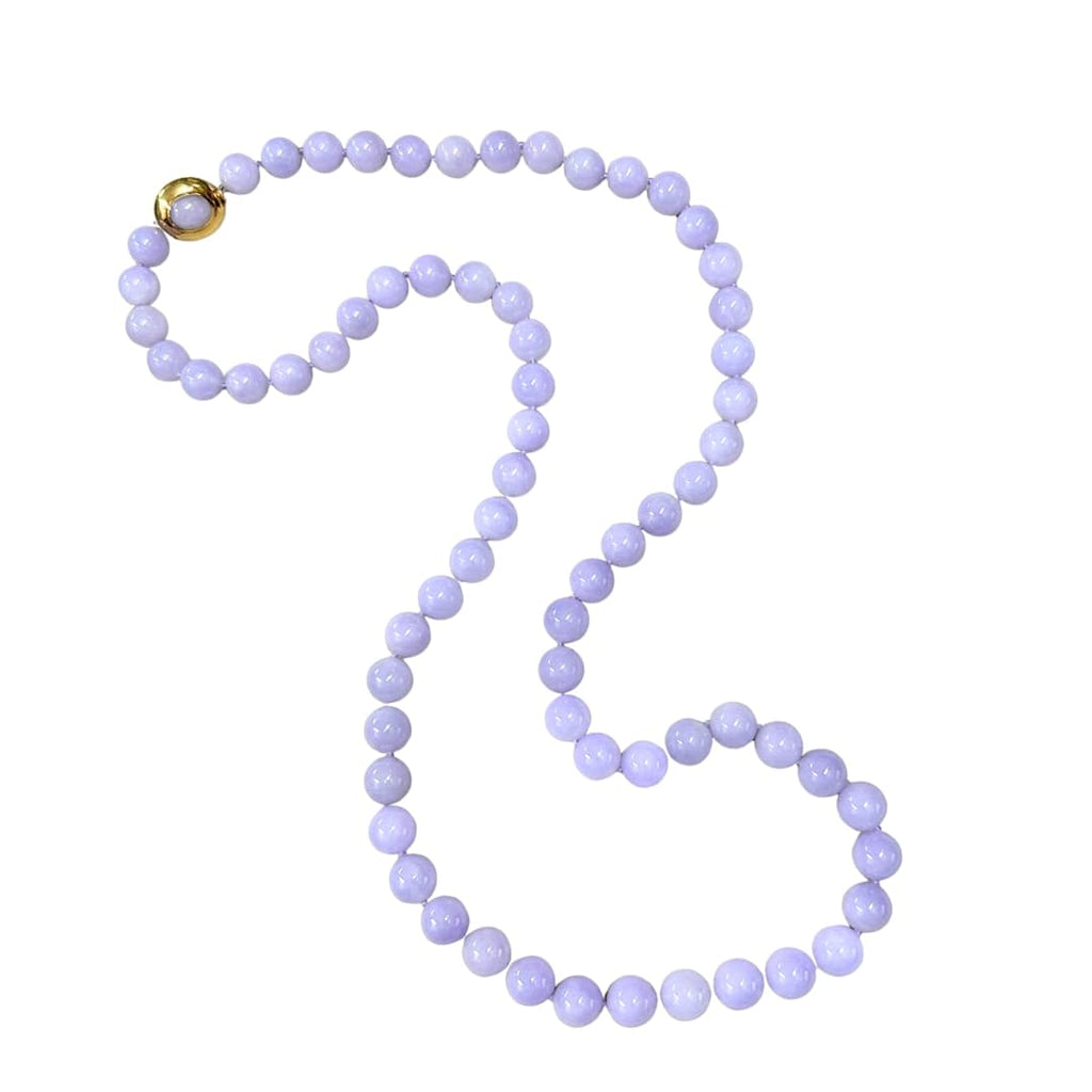Gump’s 32-inch graduated Type A lavender jade bead necklace with 18k yellow gold clasp set with cabochon jade.