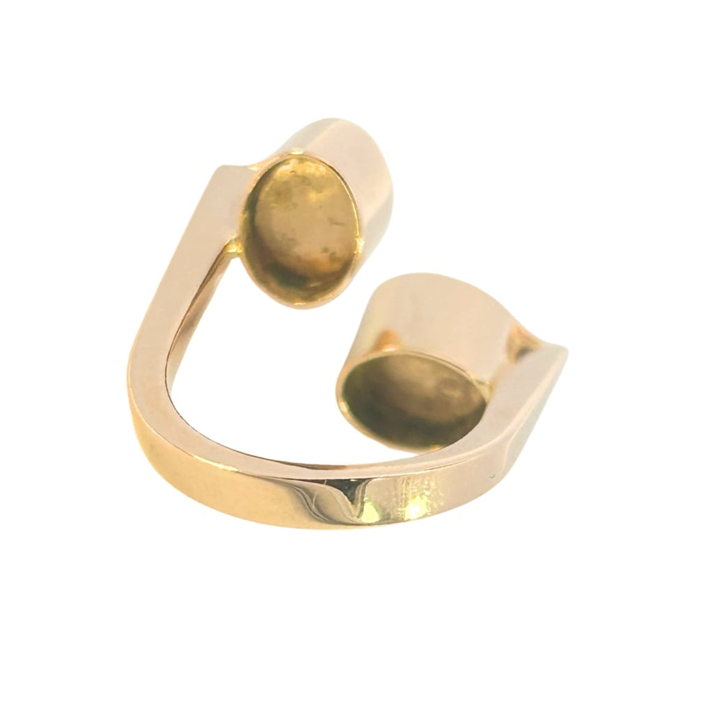 Contemporary 18k yellow gold ring with two oval opal triplets in deep bezels, set at right angles on an open shank.