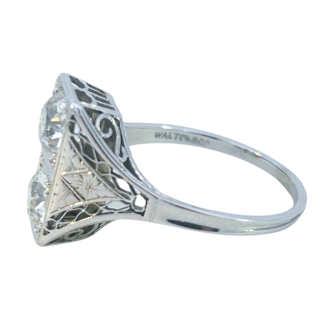 Side profile of vintage Toi et Moi ring with filigree and engraved 18K white gold details.