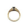 Side profile of 18k yellow gold sapphire ring with tapered baguette diamonds