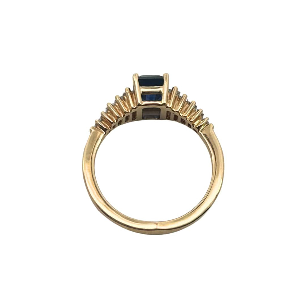 Side profile of 18k yellow gold sapphire ring with tapered baguette diamonds