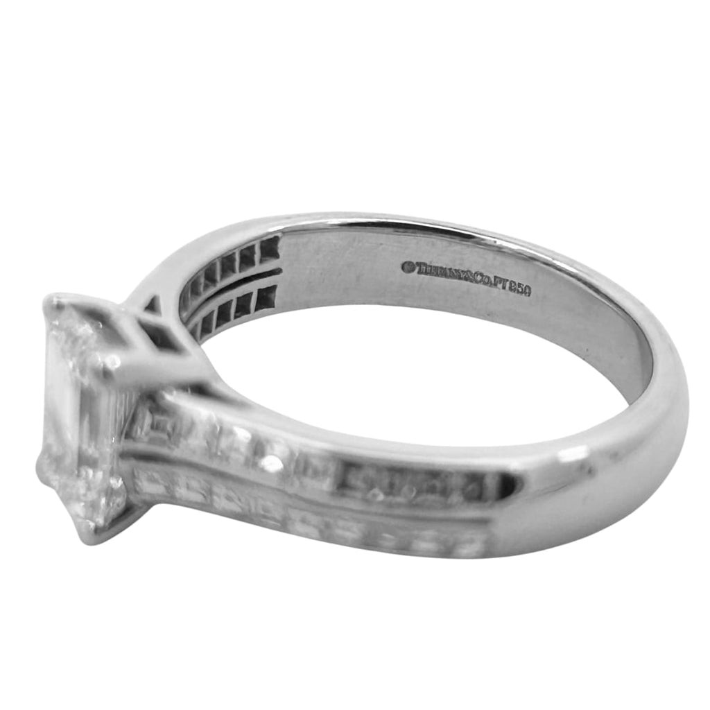 Tiffany & Co. emerald cut diamond engagement ring in platinum with a 1.14ct G/ VVS2 center diamond and channel-set square cut diamond shoulders.