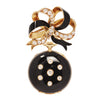 Convertible Tiffany & Co. black‑enamel lapel watch suspended from a diamond‑set gold bow brooch.