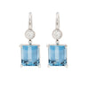 Pair of emerald cut aquamarine earrings with bezel set diamonds and French hooks in platinum.