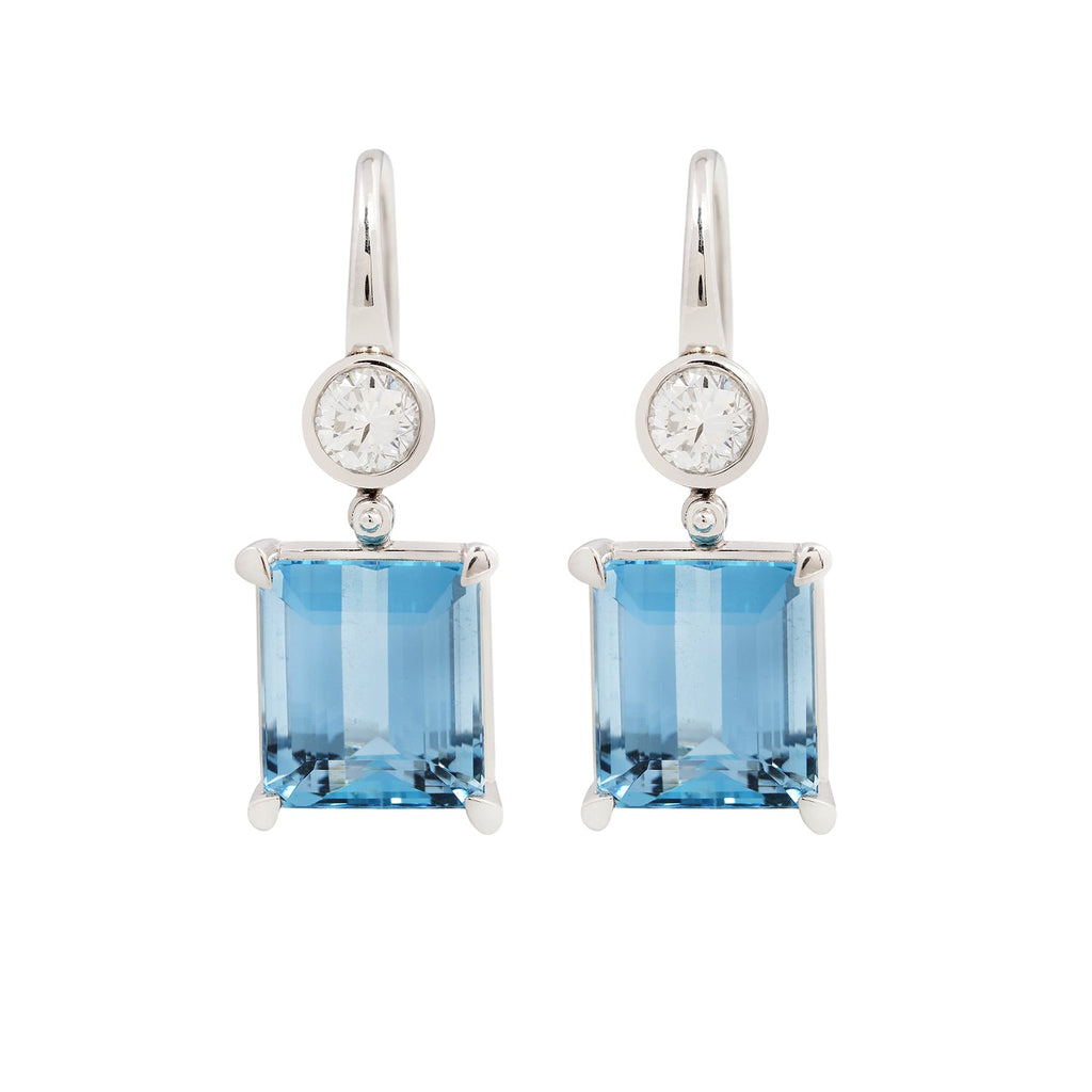 Pair of emerald cut aquamarine earrings with bezel set diamonds and French hooks in platinum.