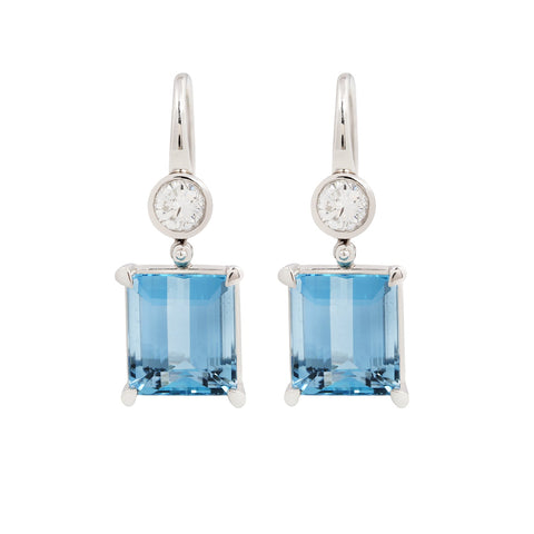 Pair of emerald cut aquamarine earrings with bezel set diamonds and French hooks in platinum.
